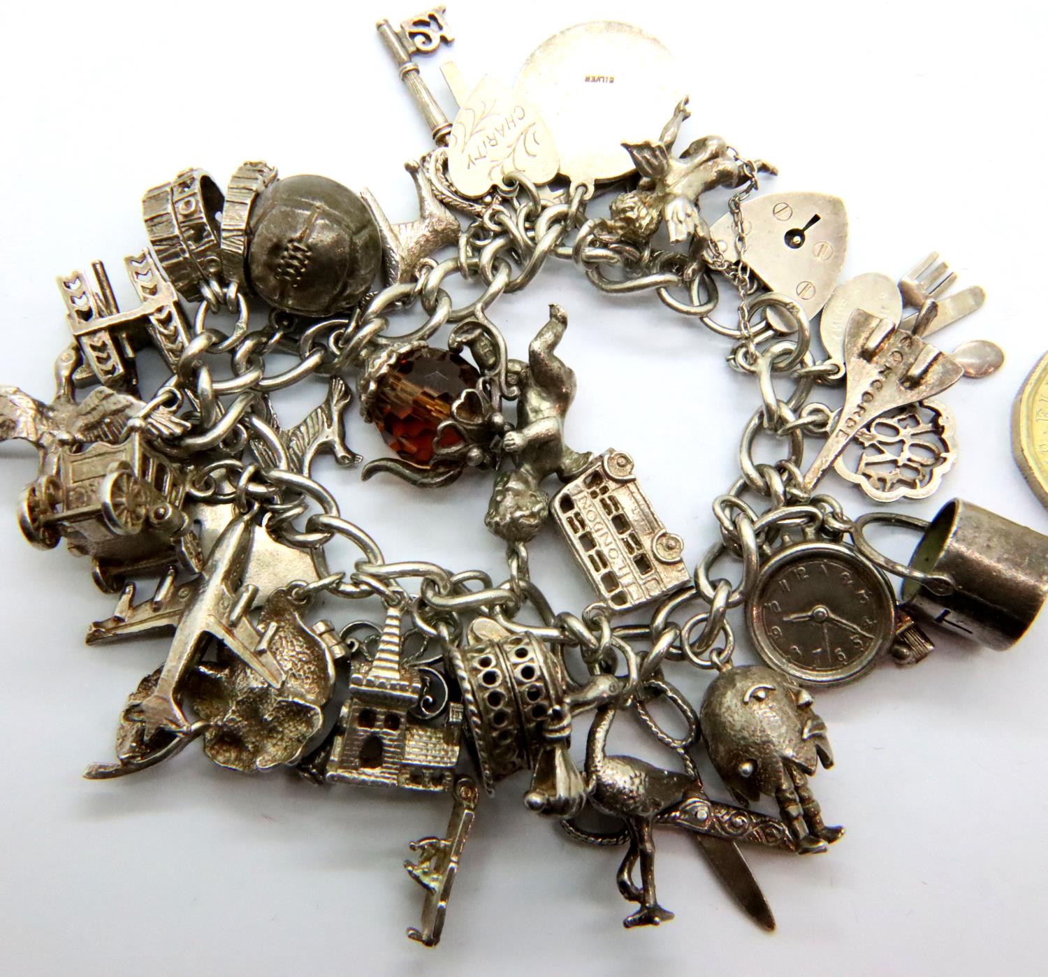 925 silver charm bracelet with padlock clasp and 29 charms, combined 91g. P&P Group 1 (£14+VAT for - Image 2 of 2