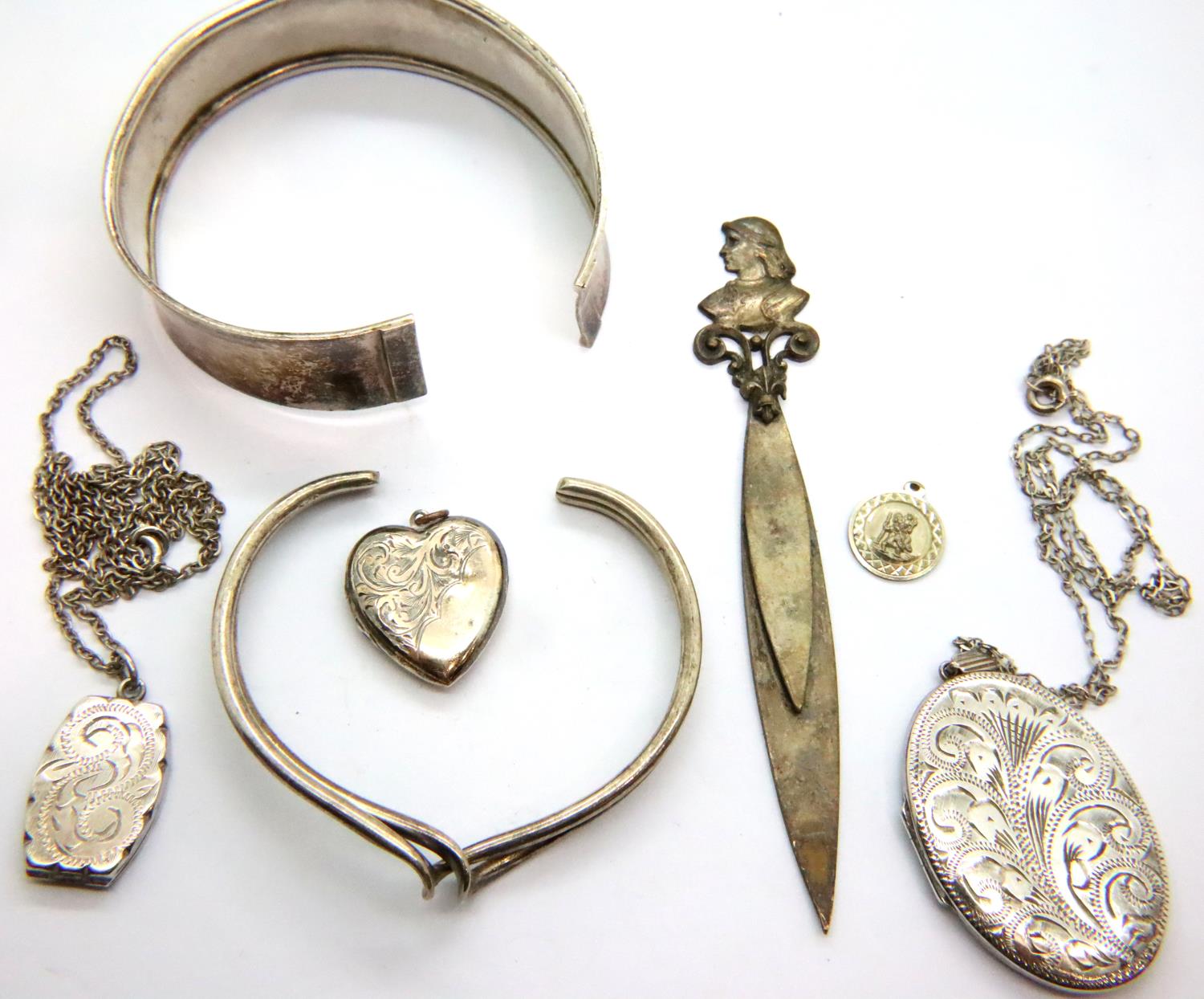 Three hallmarked silver locket pendants, two bangles and a silver plate book/page marker. P&P