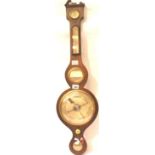 An Edwardian walnut framed aneroid barometer with thermometer, mirror and level, H: 93 cm. Not