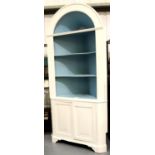 A substantial Victorian pine corner cupboard having open shelves and domed top, more recently