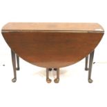 Georgian mahogany circular drop-leaf table, substantial construction with eight supports and