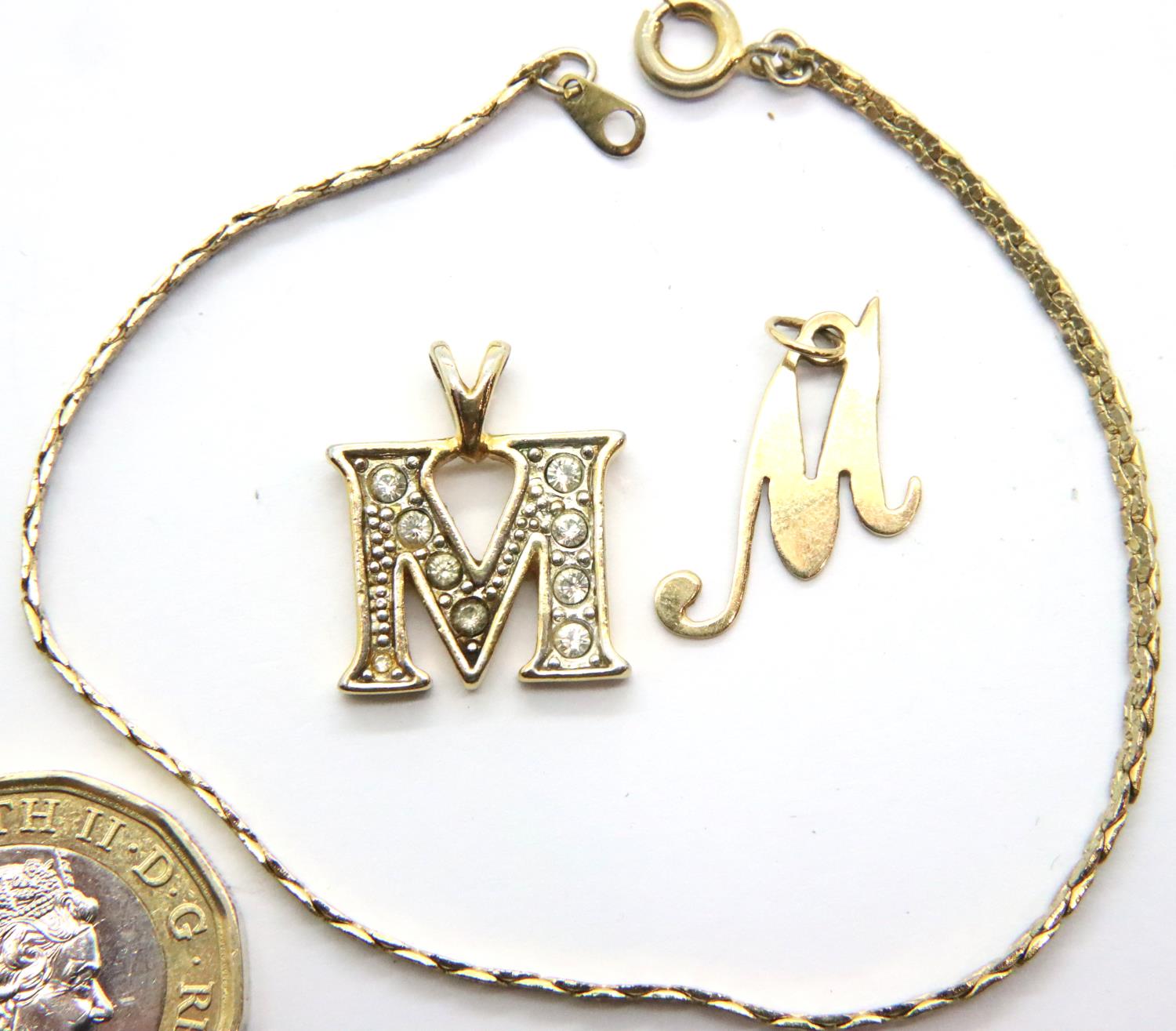 9ct gold letter M pendant, a further stone-set letter M pendant and a bracelet. P&P Group 1 (£14+VAT