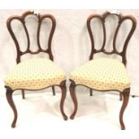 A pair of Victorian walnut parlour chairs, each more recently upholstered with serpentine-front