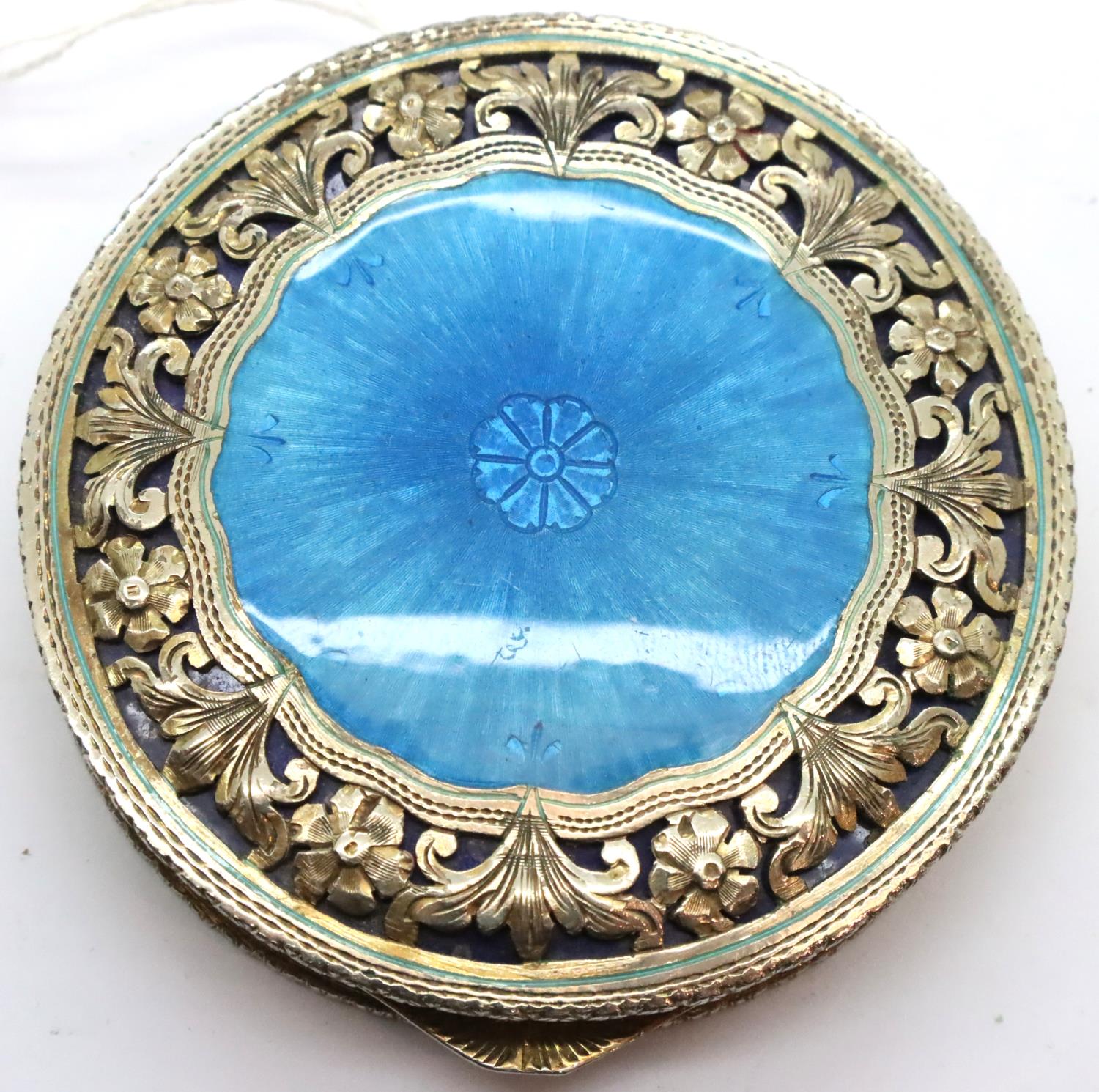 White metal and blue enamel powder compact with pierced and engraved decoration, D: 75 mm. P&P Group