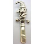 Sterling silver Mr Punch baby rattle with mother of pearl grip, L: 95 mm. P&P Group 1 (£14+VAT for