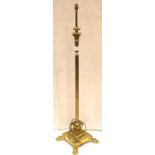 An early 20th Century brass height adjusting standard lamp of columnar form, raised on a stepped