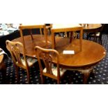 A 20th century walnut dining table with two drop in leaves and six chairs (4+2), 224 x 115 x 75 cm