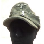 WWII German Heer M43 cap, badged, with minor moth damage. P&P Group 2 (£18+VAT for the first lot and