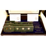 Danbury Mint, a part-filled set: Collectible Coins of America, in a large glazed display case. Not
