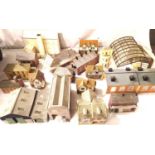 Sixteen built card OO scale buildings; station, shed, shops etc and two Hornby sheds, tunnel and