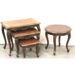 A modern mahogany nest of three graduated occasional tables with a circular coffee table. Not