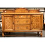 A late 19th Century oak sideboard with cupboards and drawers, bearing label for Timmins and Ashton