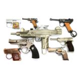 Novelty cigarette lighters all in the form of guns including a Corona example. P&P Group 2 (£18+
