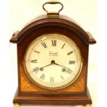 Comitti of London; a 20th Century inlaid mahogany mantle clock, with brass drum movement and chiming