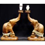 A pair of mid 20th Century carved teak lamp bases in the form of elephants, each H: 34 cm (excluding