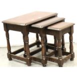 An Ercol style nest of three dark elm graduated occasional tables. Not available for in-house P&P,