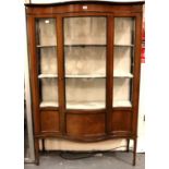 An Edwardian inlaid mahogany single door display cabinet, serpentine front with quartered veneer and