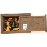 Carved box containing a complete Staunton chess set. P&P Group 3 (£25+VAT for the first lot and £5+