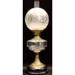 A 19th century oil lamp , the brass and glass base supporting the clear glass reservoir duplex