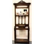 An oak Arts and Crafts period hall stand with rectangular bevelled mirror, glove box, stick stands