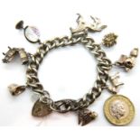 Silver charm bracelet with eight charms, combined 60g. P&P Group 1 (£14+VAT for the first lot and £