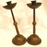 WMF; a pair of Arts and Crafts period brass candlesticks, one with damage to base, each H: 27 cm.