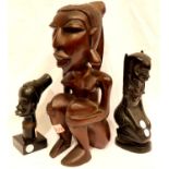 One large and two smaller carved tribal figurines, tallest H: 34 cm. P&P Group 3 (£25+VAT for the