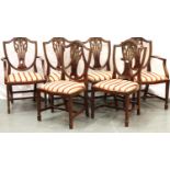 A set of six (4 plus 2) 20th Century mahogany dining chairs with shield backs and drop-in seats. Not