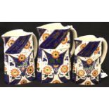 Set of three Royal Crown Derby jugs, in the Imari palette, largest with staple repair to handle,