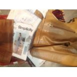 A box of simplicity kits/sewing kit, packs of clothes, pants, dresses etc along with a womens