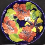 Large Moorcroft blue ground fruit bowl in the Hibiscus pattern, signed to base, D: 26 cm. P&P