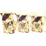 Set of three Royal Crown Derby jugs, in the Imari palette, largest with staple repair to handle,