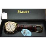 Stauer; gents wristwatch gold plated with champagne dial, brown strap, original box and paperwork.