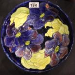 A large Moorcroft blue ground fruit bowl in the Clematis pattern, D: 26 cm. P&P Group 3 (£25+VAT for