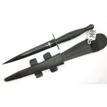 Modern Commando dagger with leather sheath, stamped with broad arrow and Sheffield England, the