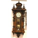 A 19th Century Bavarian walnut cased Vienna wall clock, the enamelled dial with subsidiary