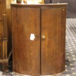 An oak George III barrel front corner cupboard with two internal shelves, W: 67, H: 84 cm. Not