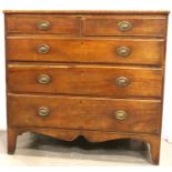 A Regency inlaid walnut chest of two short above three long drawers, raised on shaped bracket