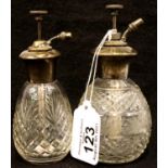 Two silver topped cut glass perfume atomisers, one hallmarked silver and the other sterling