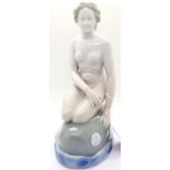 Nude seated female figurine in style of Royal Copenhagen. H: 25 cm. P&P Group 3 (£25+VAT for the