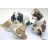 Nao and Lladro ceramic figurines to include Gentle Surprise and two puppies playing. P&P Group 2 (£