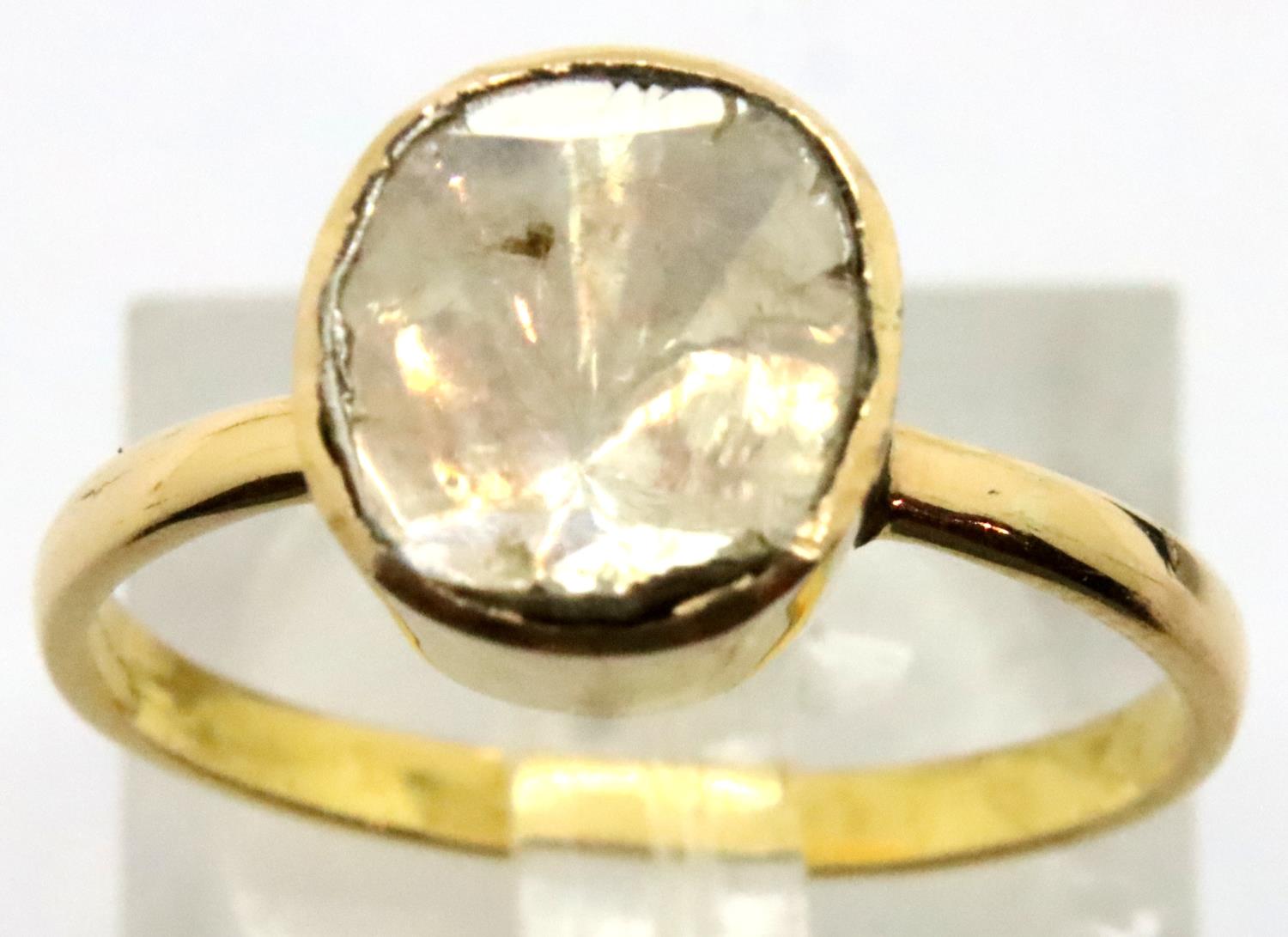 Yellow metal and 1.5ct rough cut diamond solitaire in closed back ring, size O. P&P Group 1 (£14+VAT