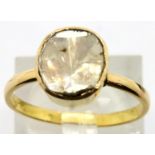Yellow metal and 1.5ct rough cut diamond solitaire in closed back ring, size O. P&P Group 1 (£14+VAT