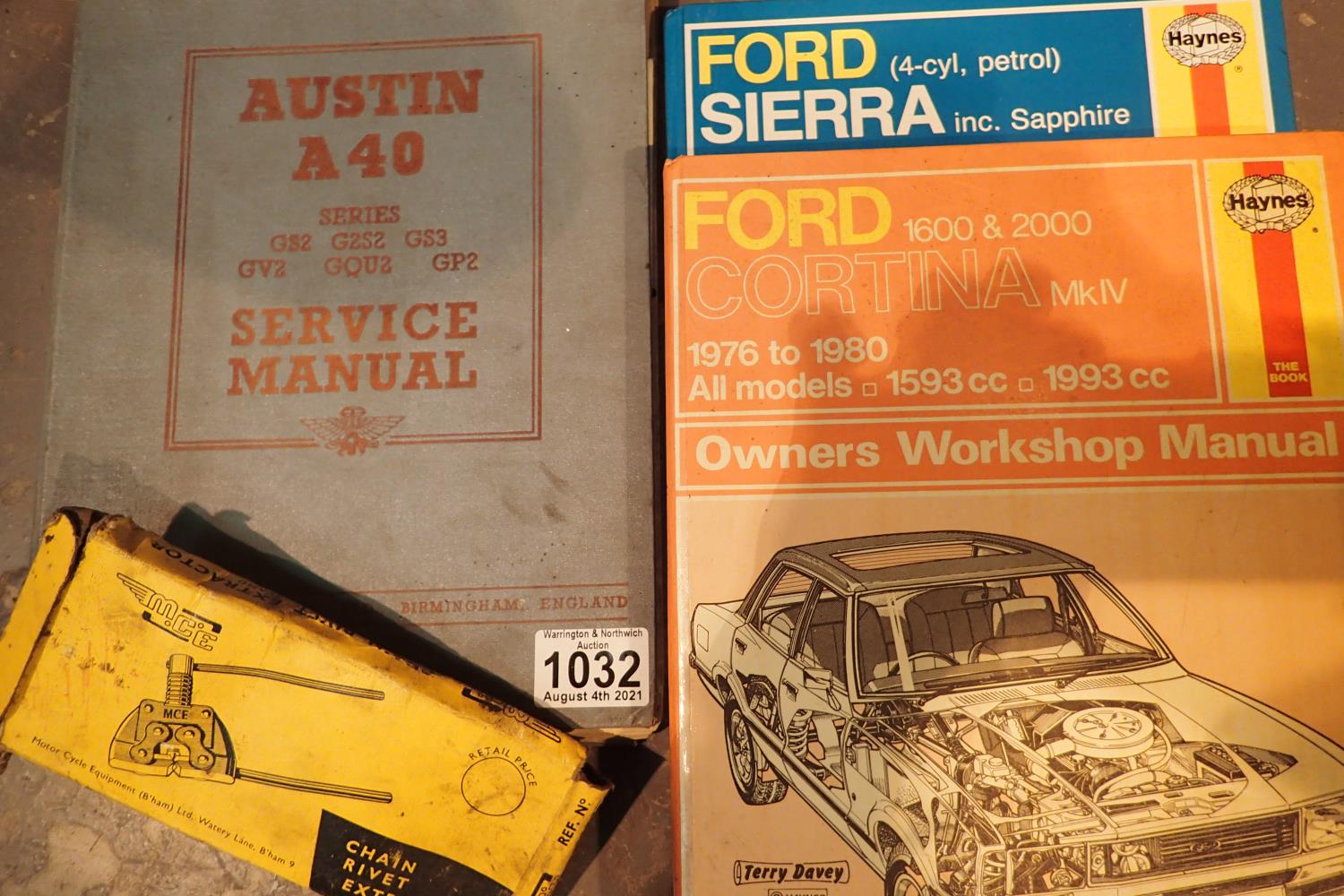 Two Haynes car repair manuals, Sierra and Cortina, a vintage Austin A40 manual and a motorcycle