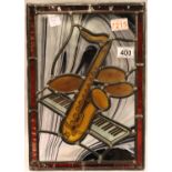 Leaded glass saxophone and keyboard panel, signed CJ, 27 x 39 cm. Not available for in-house P&P,