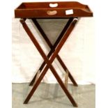 An Edwardian mahogany butlers twin handled tray on a folding support with two further folding tray