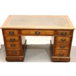 Oak nine drawer desk with leather inset top, 122 x 65 cm. Not available for in-house P&P, contact