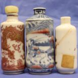 Three 18th-19th century Chinese ceramic snuff bottles, each of cylindrical form. The shortest with