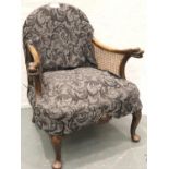 A 1930s walnut framed salon chair with carved arm terminals and two bergere panels, more recently