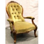 A Victorian walnut framed spoon back parlour chair with scrolling carved arms and buttoned back